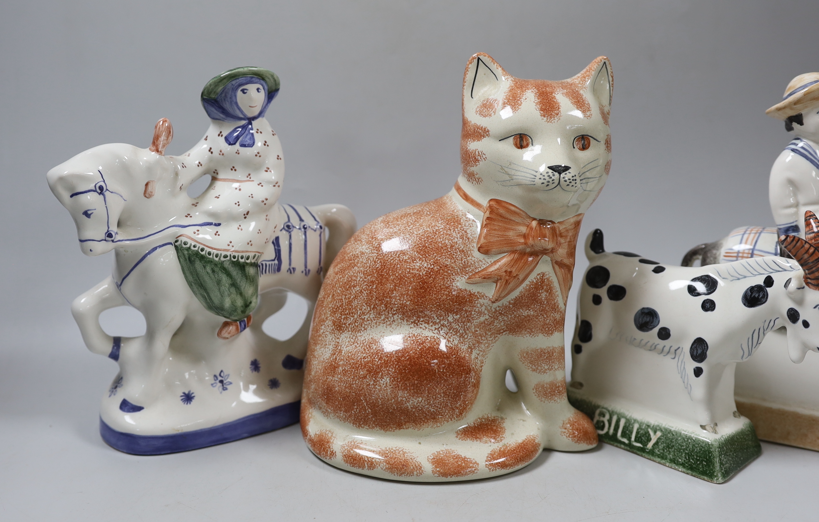 A Rye pottery Billy the goat, a boy riding a donkey, a lady on horseback and a cat, 20cm high (4)